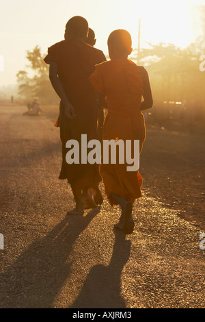 Silhouette Of Monks At Dawn Collecting Alms Stock Photo