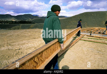 Construction worker showing the proper way to carry an I Joist Boise Idaho Stock Photo