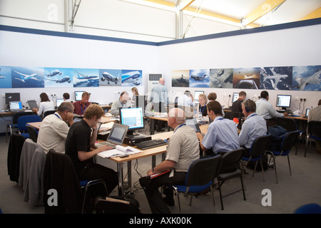 Journalists at work on their computers in communications centre at Farnborough International Airshow July 2006 How business is d Stock Photo