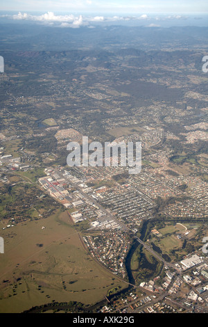 High level oblique aerial view of fields and houses from civil aircraft window flying near Brisbane Queensland QLD Australia Stock Photo