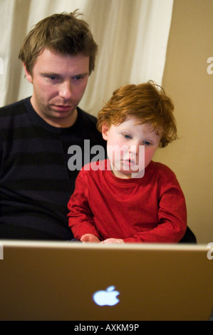 Father and son using a lap top computer Stock Photo