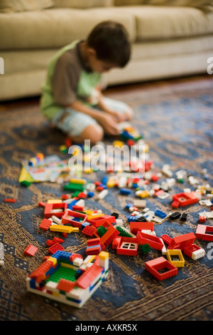 Boy aged six years plays with Lego building blocks Stock Photo