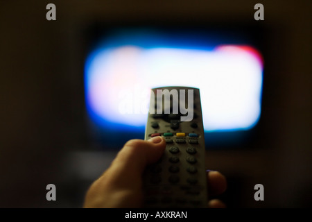 Man holds buttons while watching TV Stock Photo