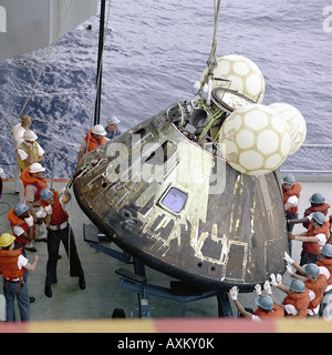 Crewmen aboard the U S S Iwo Jima prime recovery ship for the Apollo 13 mission hoist the Command Module aboard ship Stock Photo