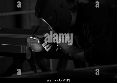 Stock photo of a masked welder welding in a factory The photo was taken in a light industrial unit in St Junien France Stock Photo