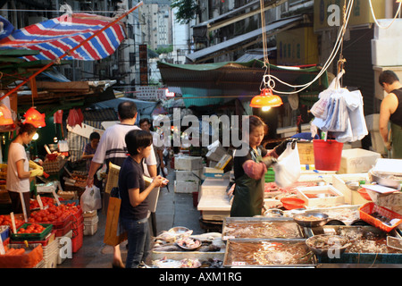 Street Food Market in Hong Kong - Lady Selling Fish [Graham Street Market, Graham Street, Hong Kong, China, Asia].             . Stock Photo