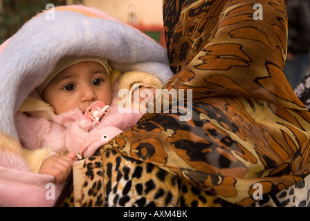Libyan woman carrying her baby in the Medina or Old Town Tripoli Libya Stock Photo