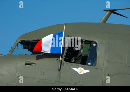 Old airplane Douglas DC-3 Dakota (C-47) with a french flag on the cockpit during a french vintage air show at La Ferte Alais Stock Photo
