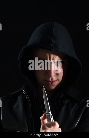 Teenage thug in hoody with knife Stock Photo