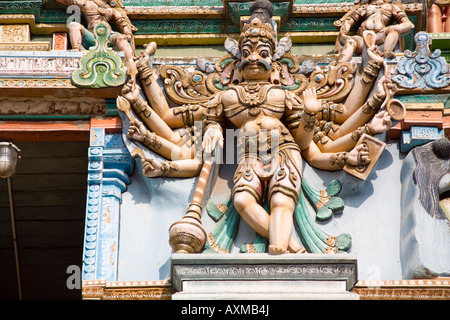 Carved male deity with ten arms on a gopuram, Meenakshi Temple, Madurai, Tamil Nadu, India Stock Photo