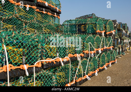 Stacked lobster crab pots pot trap traps fishing equipment on quayside close up England UK United Kingdom GB Great Britain Stock Photo