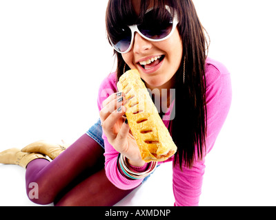 Teenage Girl Eating Sausage Roll Model Released Stock Photo