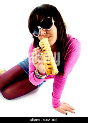 Teenage Girl Eating Sausage Roll Model Released Stock Photo