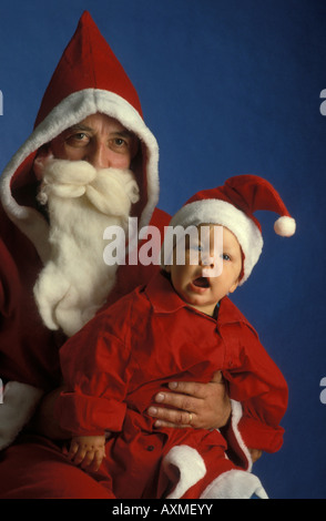 Santa Claus and his little apprentice. Father Christmas and his little assistant. Père Noël. Paire Noël. Stock Photo