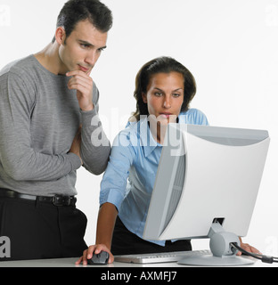 Businesswoman and businessman using computer Stock Photo