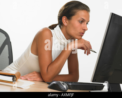Businesswoman looking at computer screen Stock Photo