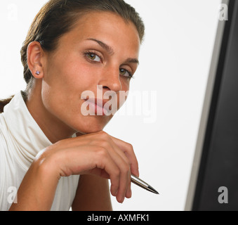 Businesswoman holding pen and smiling Stock Photo