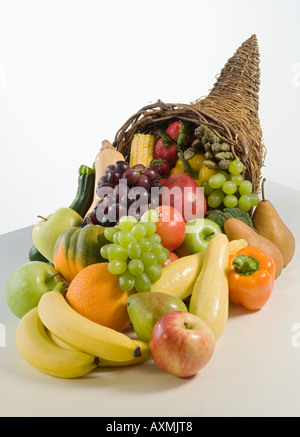 Fruits and vegetables in cornucopia basket Stock Photo