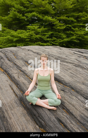 Woman practicing yoga in park Stock Photo