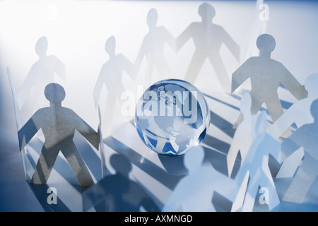 Chain of paperdoll cutouts with globe in center Stock Photo