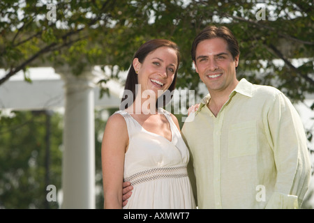 Couple hugging and smiling outdoors Stock Photo