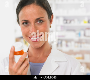 Close up of female pharmacist holding medication Stock Photo