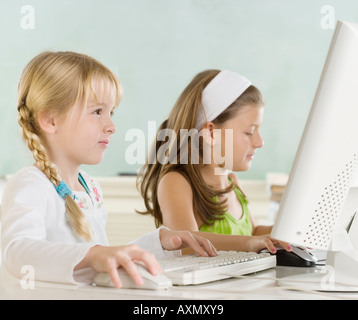 Two young girls using computers Stock Photo