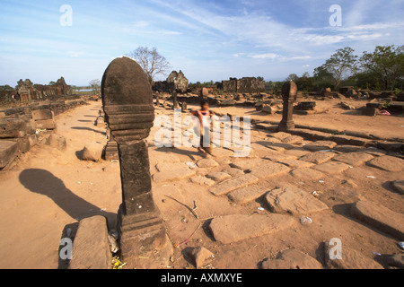 Girl Walking Along Pillared Pathway, Wat Phu Champasak Stock Photo