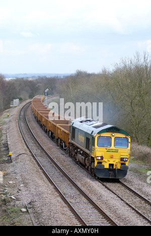 Class 66 diesel locomotive pulling empty ballast train at Hatton Bank, Warwickshire, UK Stock Photo