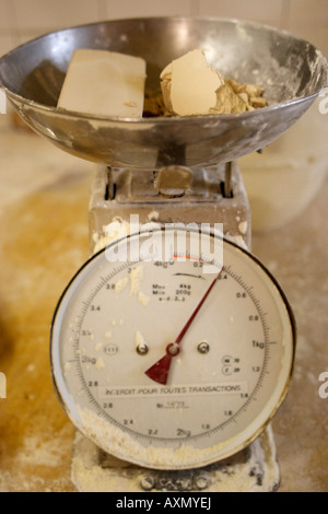 baker weighing bread dough on scale at bakery Stock Photo - Alamy