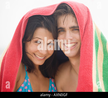 Couple smiling with towel over their heads Stock Photo