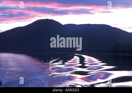 Sunset reflected in boat wake on the ocean waves in Frederick Sound Inside Passage Alaska Stock Photo