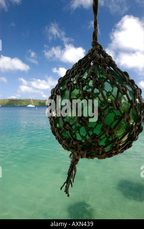 A glass fishing float hangs in the Port of Refuge harbor in Neiafu Kingdom of Tonga Stock Photo
