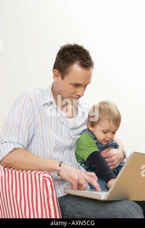 Father and son using a laptop Stock Photo