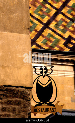 The Owl is the symbol of Dijon in Burgundy seen here crafted in painted wrought iron outside a restaurant Stock Photo