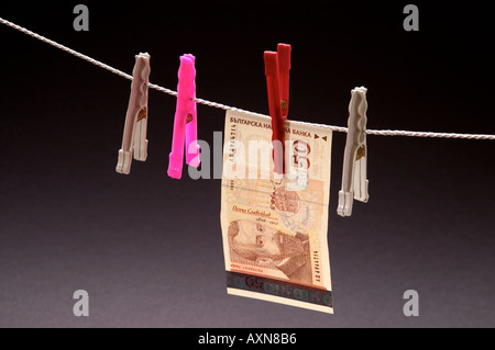 Washed money hanged on a rope currency pegs BGN 50 leva euro note dirty money drying Stock Photo