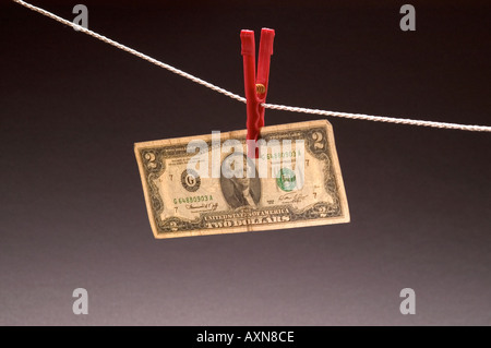 Washed money hanged on a rope currency pegs dollars note dirty money drying Stock Photo