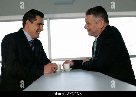 Two businessmen talking while they having a cup of espresso Stock Photo