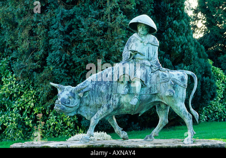 Bronze statue of ancient Chinese Taoist philosopher Lao Tzu riding an ox in Duffryn Gardens, South Glamorgan, Wales, UK Stock Photo