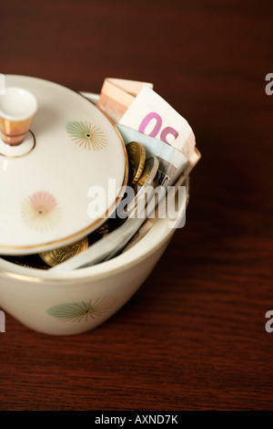Sugar bowl filled with Euro bills (part of), close-up Stock Photo