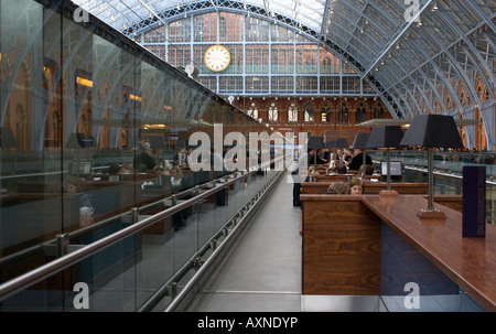 Champagne bar St.Pancras Station. overhead architectural metal work and clock in distance Stock Photo