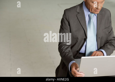 Elderly manager working on a laptop Stock Photo