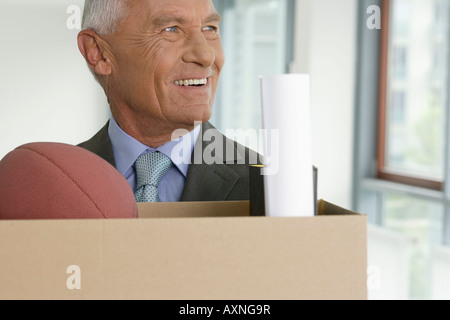 Elderly manager looking sideways, smiling Stock Photo