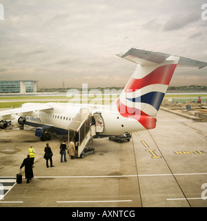 passengers boarding British Airways jet. No model release required as distance and back views makes all people unrecognizable Stock Photo