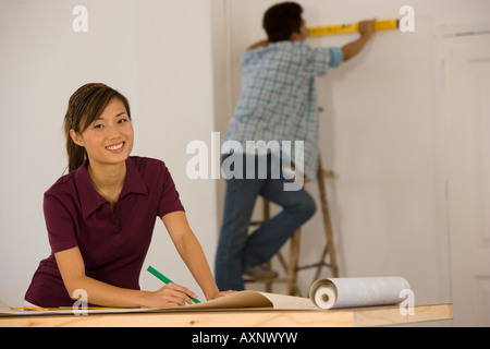 Asian couple hanging wall paper Stock Photo