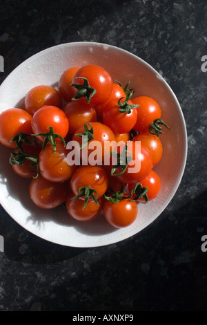 ceramic bowl of cherry tomatoes in a kitchen Stock Photo