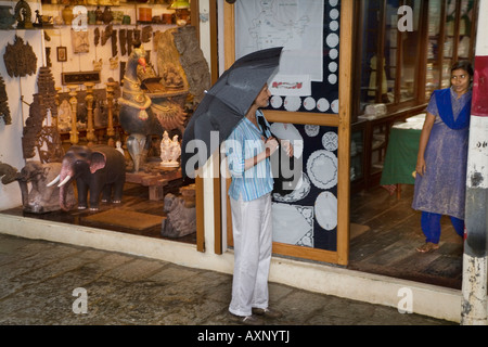 Indian salesgirl inviting a tourist to visit her Hand Embroidery Store in Jew town Mattancherry, Kochi Cochin Kerala South India Stock Photo