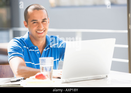 Young man typing on laptop Stock Photo