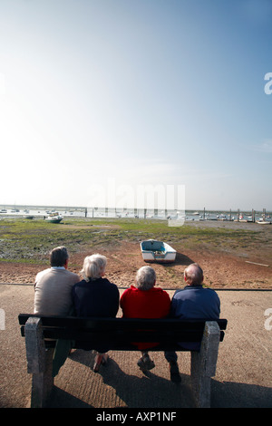 VISITORS TO WEST MERSEA SIT AND ADMIRE THE SEA VIEW Stock Photo