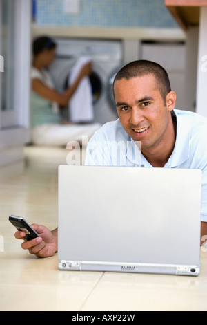 Young man using laptop on floor Stock Photo
